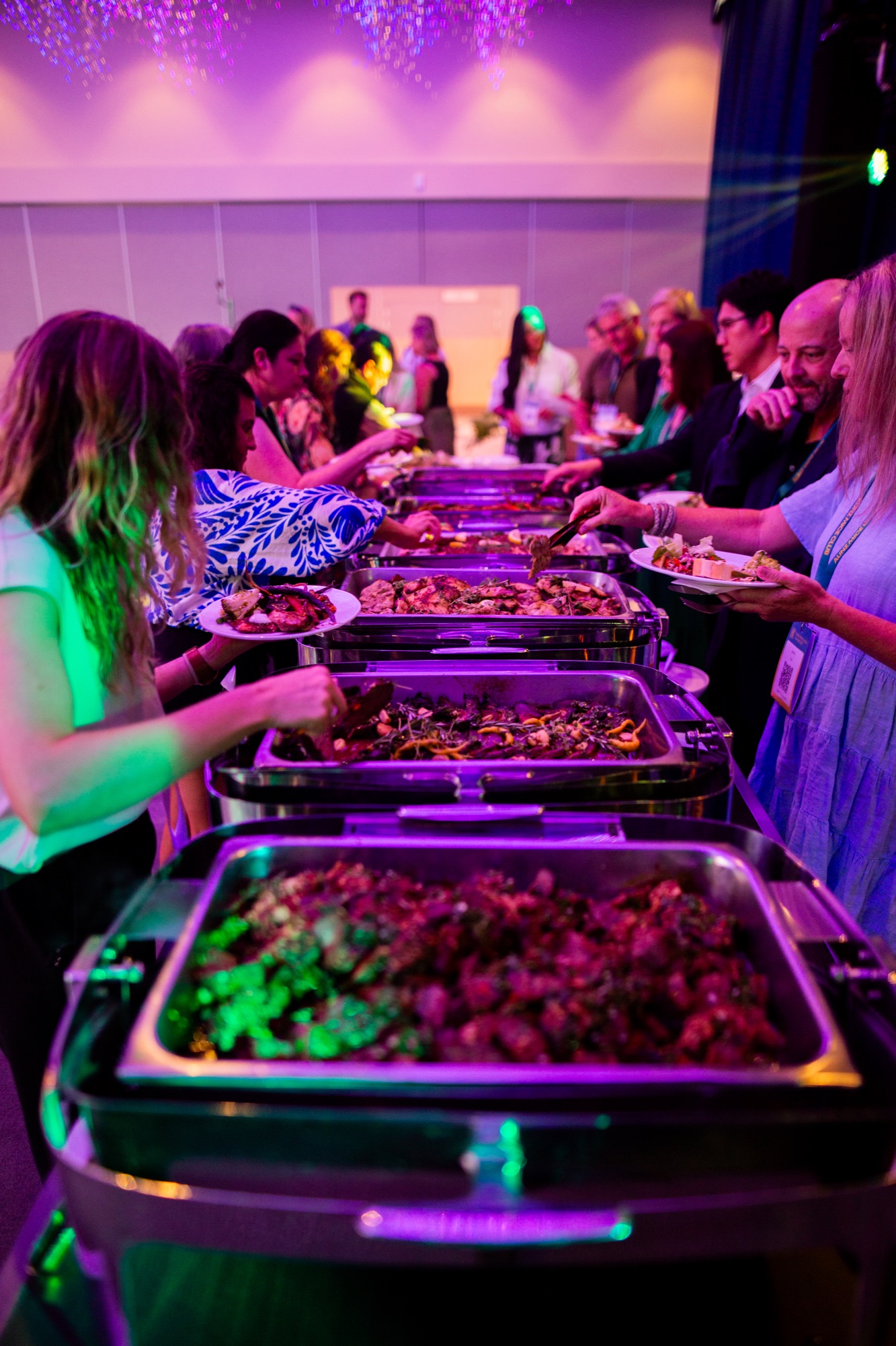 Event professionals gathered around the food station
