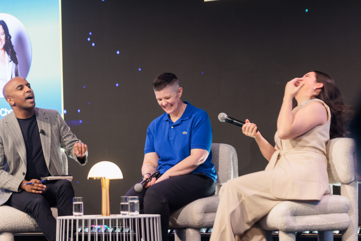 Panel speakers sharing a moment on stage at the Sydney event